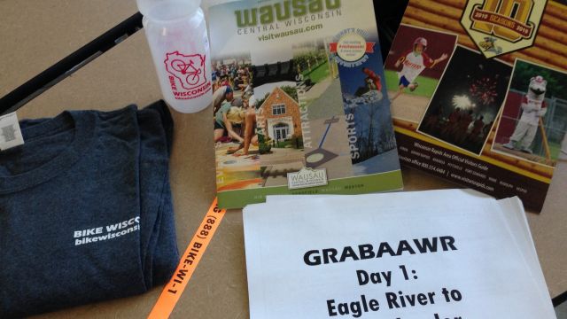 cue sheets, water bottle, t-shirt and pamphlets