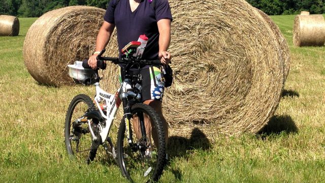 Paul and bike in front of hay roll