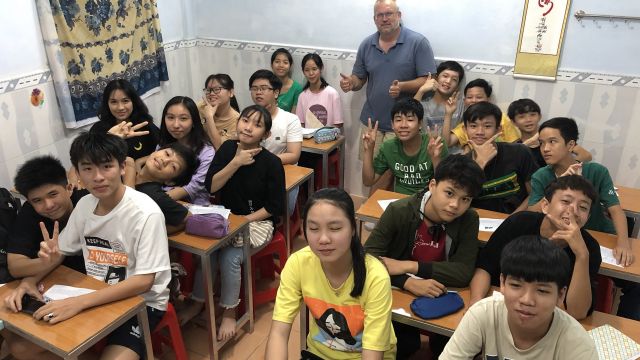 Paul and a class of junior high school students.
