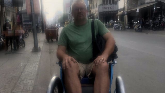 Paul getting a ride on bicycle rickshaw.