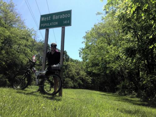 Paul and bike under West Baraboo sign