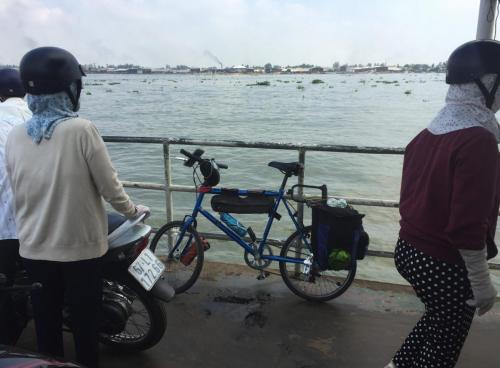 bicycle leaning against rail on the deck of ferry