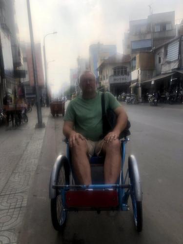 Paul getting a ride on bicycle rickshaw.